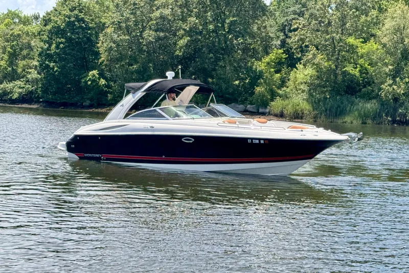 Slide: The Image of 2005 Monterey 298SS Super Sport boat cruising on a serene lake. - 1