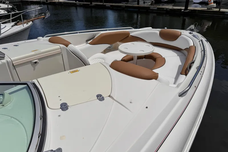 Slide: The Image of 2005 Monterey 298SS Super Sport boat with white and brown seating at a marina. - 11