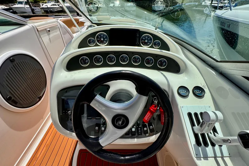 Slide: The Image of Cockpit of 2005 Monterey 298SS Super Sport boat with steering wheel and gauges. - 15