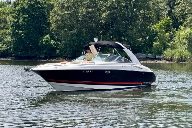 Slide: The Image of 2005 Monterey 298SS Super Sport boat cruising on a calm lake. - 2