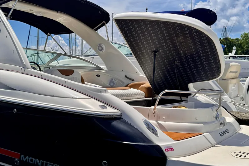 Slide: The Image of 2005 Monterey 298SS Super Sport boat with open engine hatch at marina. - 21
