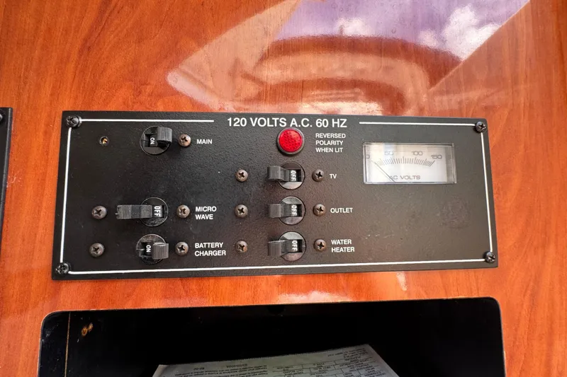 Slide: The Image of Electrical panel of a 2005 Monterey 298SS Super Sport boat, showing switches and voltage meter. - 24