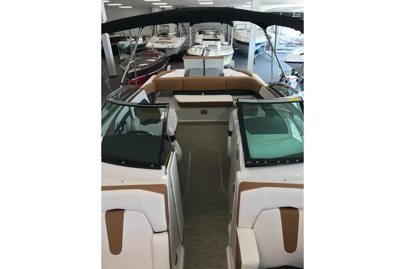 Slide: The Image of 2018 Four Winns H260 boat interior with seating and windshield in showroom. - 4