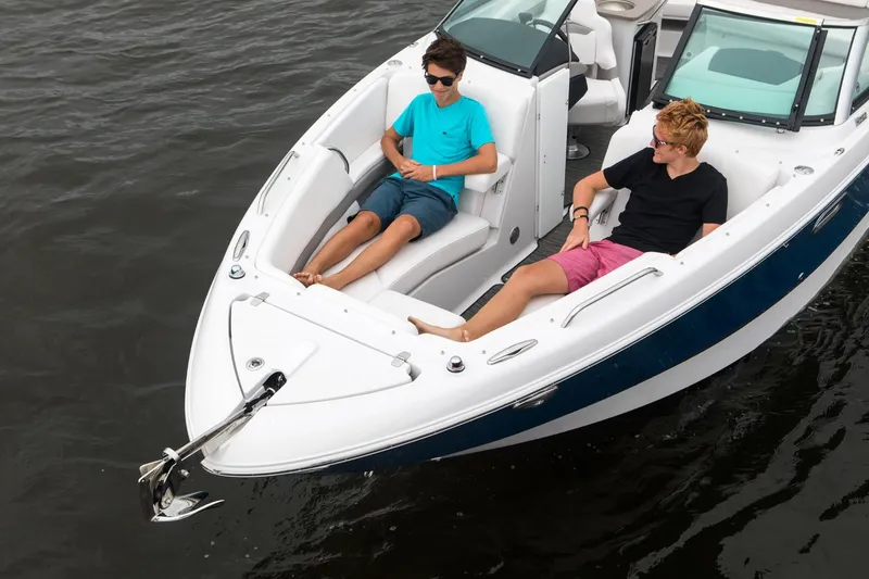 Slide: The Image of Manufacturer Provided Image: 2018 Four Winns H260 boat with two people relaxing on the bow. - 7
