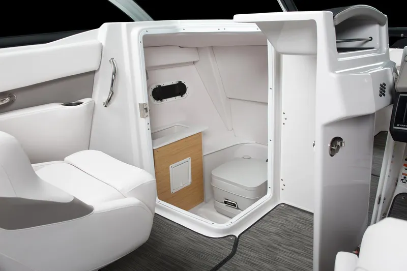 Slide: The Image of Manufacturer Provided Image: 2018 Four Winns H260 boat interior with compact bathroom and seating. - 9