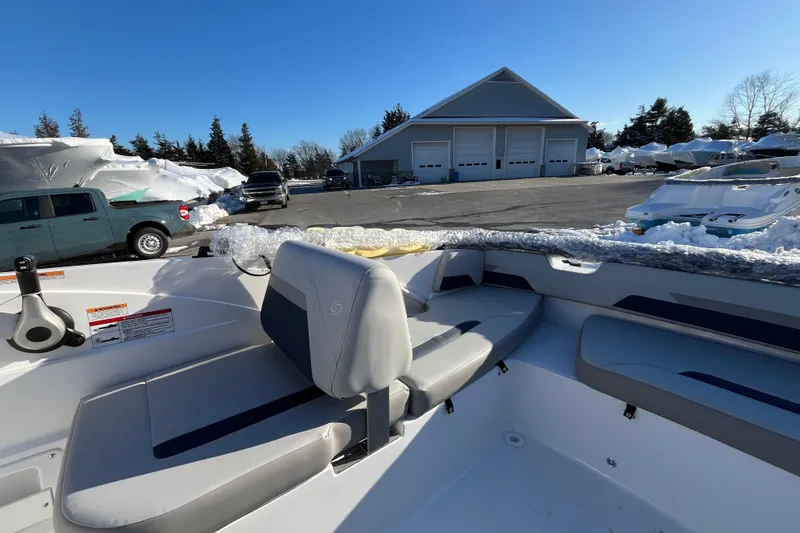 Slide: The Image of 2026 Hurricane SunDeck Sport 185 OB boat interior with seating, parked outdoors. - 12