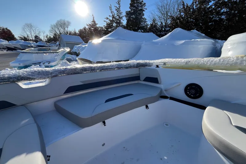 Slide: The Image of 2026 Hurricane SunDeck Sport 185 OB boat interior with seating, wrapped for winter storage. - 13