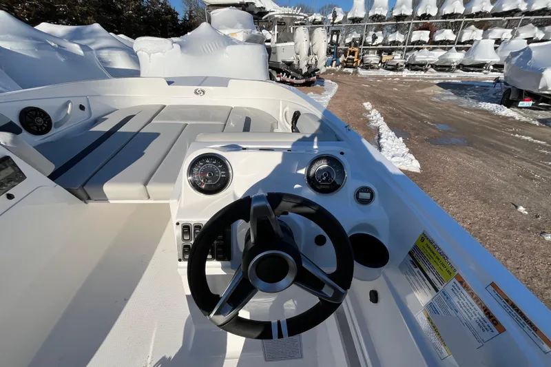 Slide: The Image of 2026 Hurricane SunDeck Sport 185 OB boat interior with steering wheel and gauges. - 15