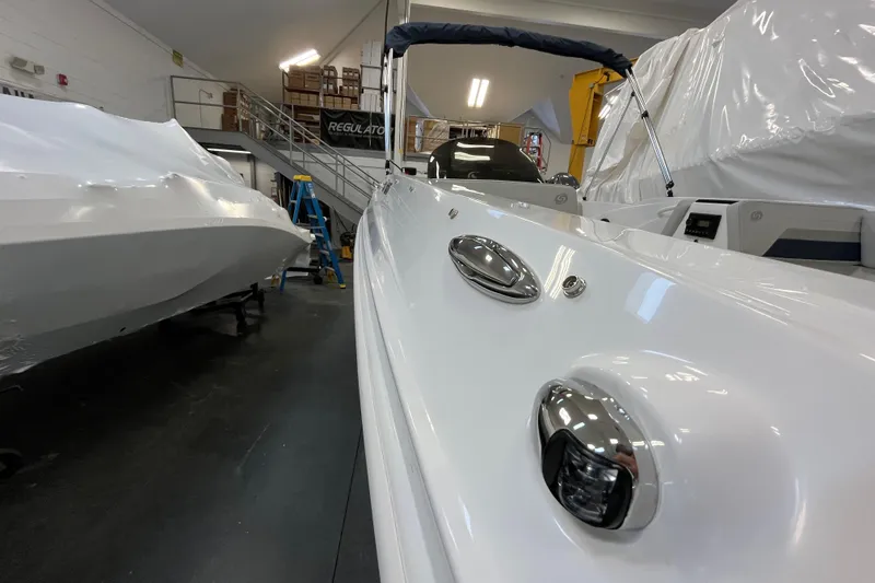 Slide: The Image of 2026 Hurricane SunDeck Sport 185 OB boat in showroom, sleek design, white finish. - 23