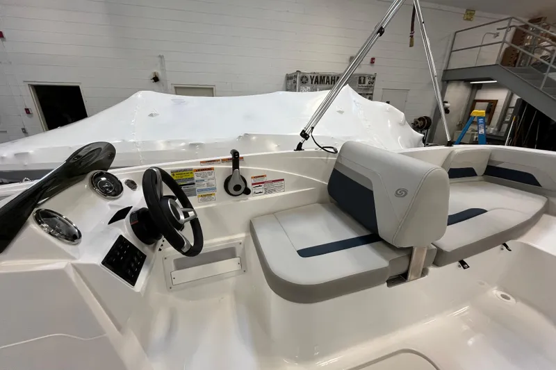 Slide: The Image of 2026 Hurricane SunDeck Sport 185 OB boat interior with steering wheel and seating. - 25