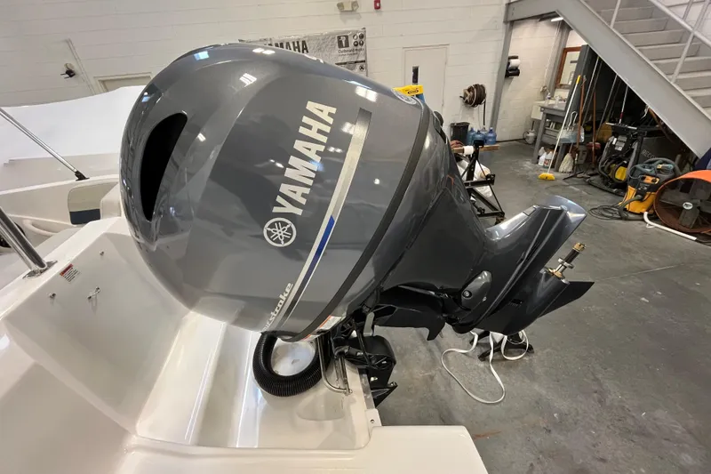 Slide: The Image of 2026 Hurricane SunDeck Sport 185 OB with Yamaha outboard motor in a workshop setting. - 29