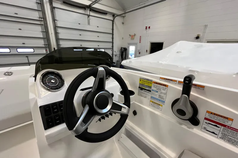 Slide: The Image of 2026 Hurricane SunDeck Sport 185 OB boat dashboard with steering wheel and control panel. - 30