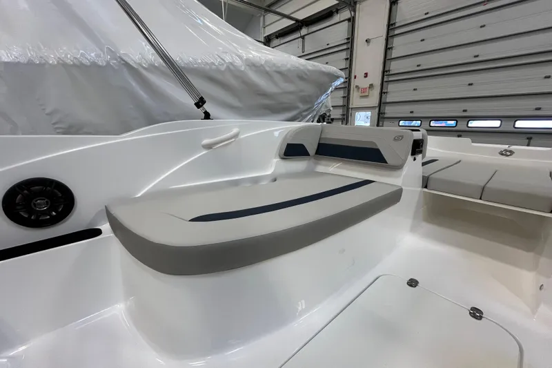 Slide: The Image of 2026 Hurricane SunDeck Sport 185 OB boat interior with cushioned seating in a garage. - 33