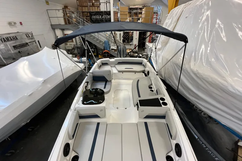 Slide: The Image of 2026 Hurricane SunDeck Sport 185 OB boat interior with seating and canopy in showroom. - 35