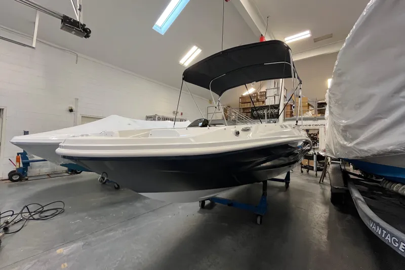 Slide: The Image of 2026 Hurricane SunDeck Sport 185 OB boat in indoor storage facility. - 5