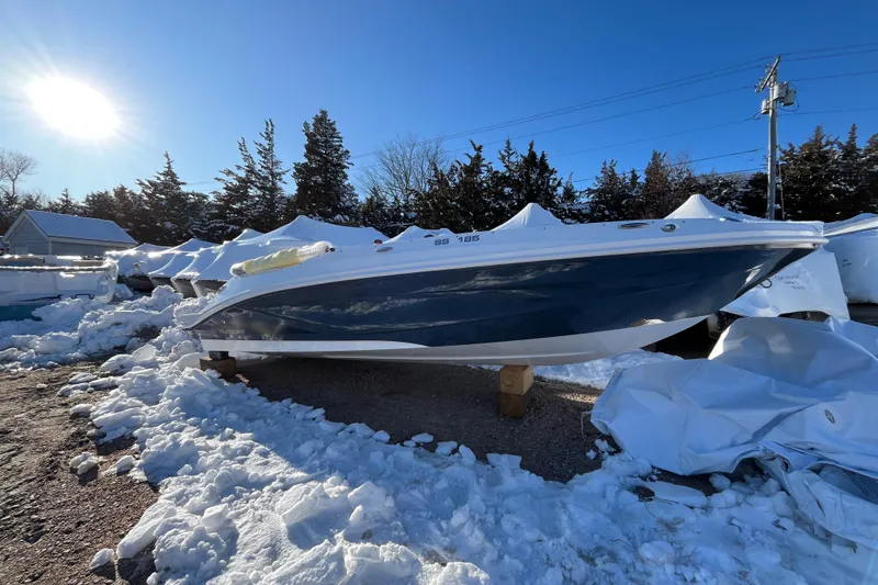 Slide: The Image of 2026 Hurricane SunDeck Sport 185 OB boat in snowy outdoor storage. - 7