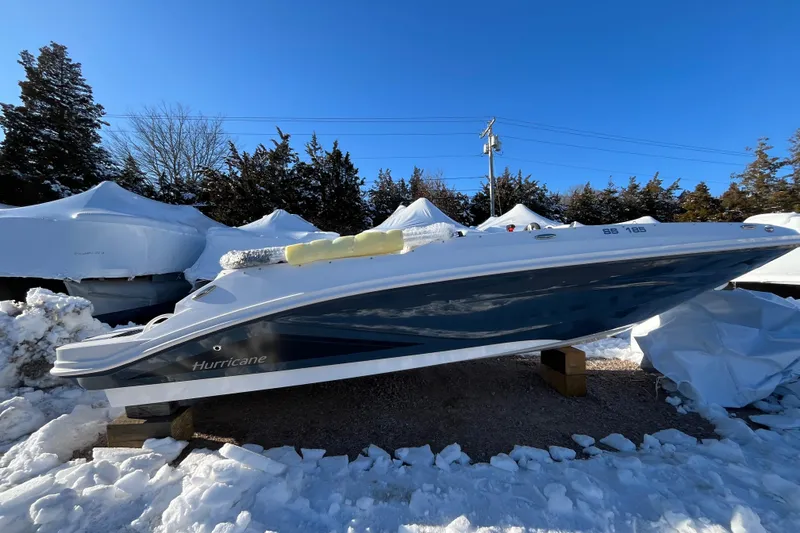 Slide: The Image of 2026 Hurricane SunDeck Sport 185 OB boat in snowy outdoor storage. - 8