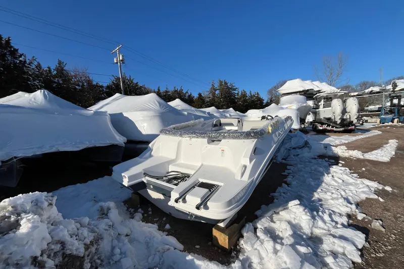Slide: The Image of 2026 Hurricane SunDeck Sport 185 OB boat in snowy outdoor storage area. - 9