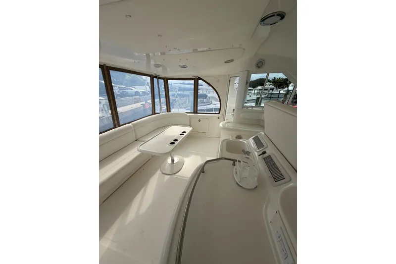 Slide: The Image of Luxurious interior of 2004 Sea Ray 480 Sedan Bridge yacht with panoramic windows. - 14