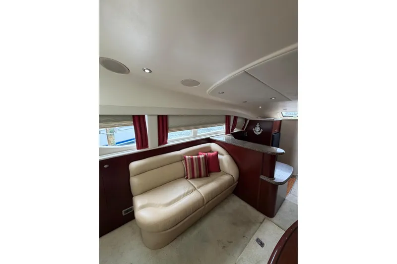 Slide: The Image of Luxurious interior of 2004 Sea Ray 480 Sedan Bridge yacht with plush seating and elegant design. - 17