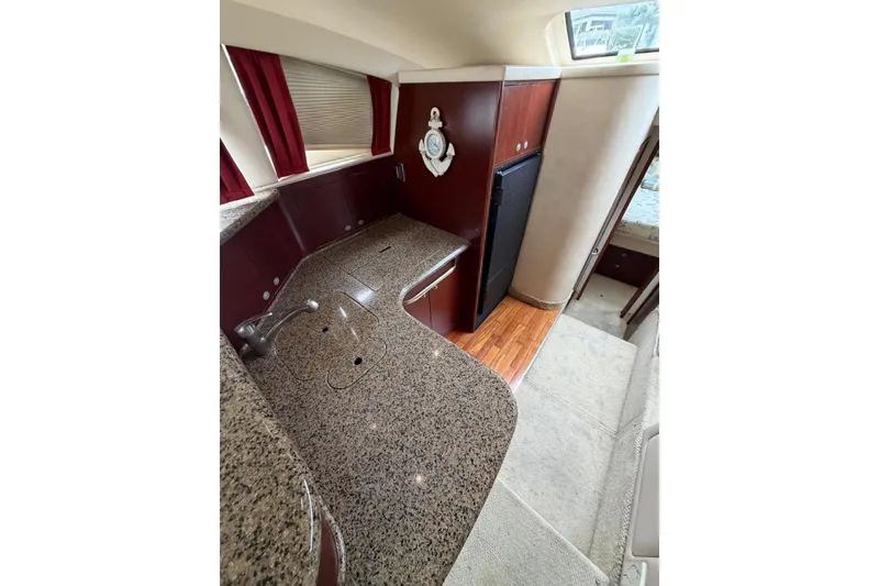 Slide: The Image of 2004 Sea Ray 480 Sedan Bridge yacht interior with granite countertops and wood flooring. - 18