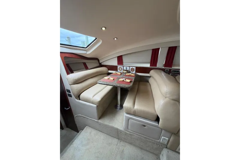 Slide: The Image of Luxurious interior of 2004 Sea Ray 480 Sedan Bridge with plush seating and dining area. - 24