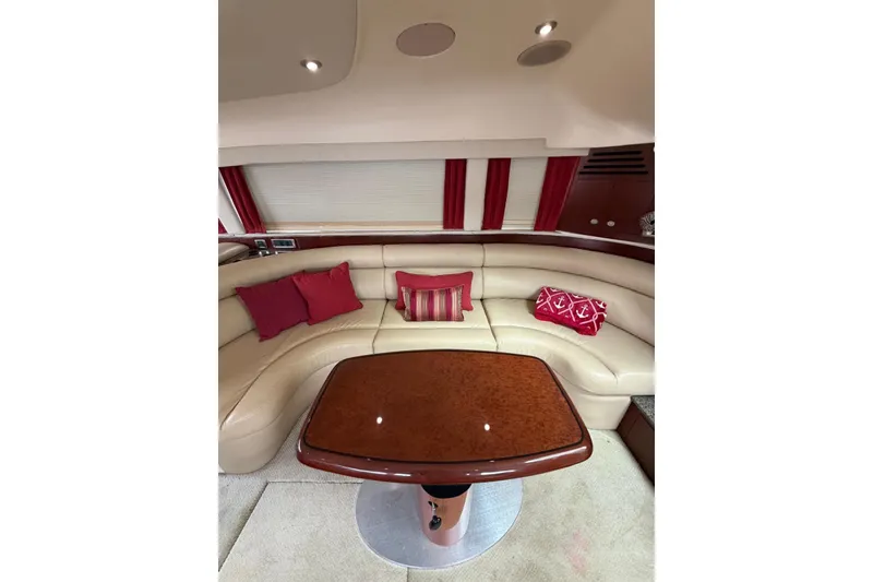 Slide: The Image of Luxurious interior of 2004 Sea Ray 480 Sedan Bridge with cream leather seating and red accents. - 26