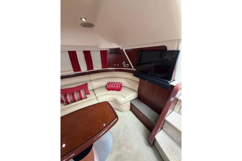 Slide: The Image of Luxurious interior of 2004 Sea Ray 480 Sedan Bridge with plush seating and TV. - 27