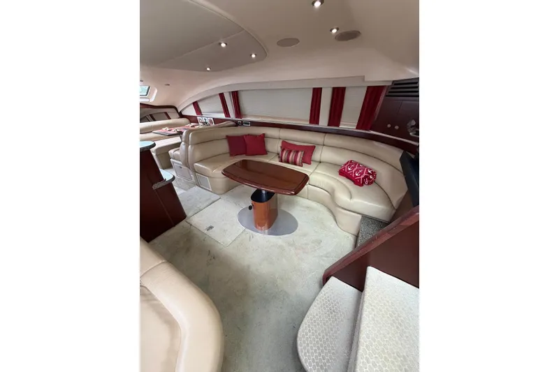 Slide: The Image of Luxurious interior of 2004 Sea Ray 480 Sedan Bridge with plush seating and elegant decor. - 28