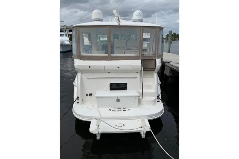 Slide: The Image of 2004 Sea Ray 480 Sedan Bridge yacht docked at marina, rear view. - 3