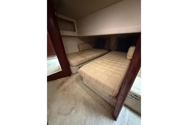 Slide: The Image of 2004 Sea Ray 480 Sedan Bridge cabin with twin beds and beige upholstery. - 41
