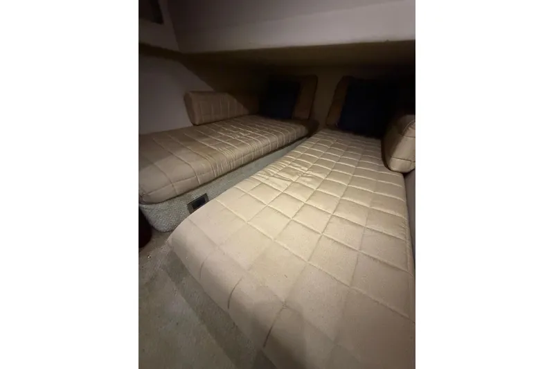 Slide: The Image of Interior cabin of 2004 Sea Ray 480 Sedan Bridge with beige cushioned seating. - 43