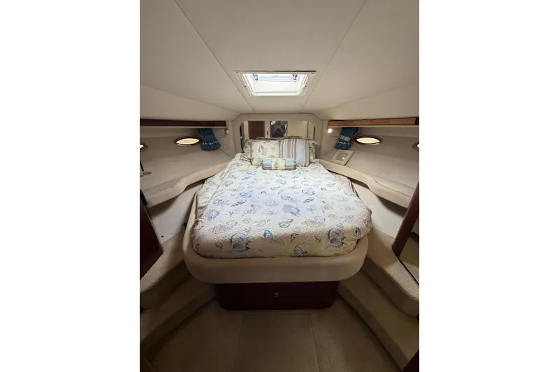 Slide: The Image of 2004 Sea Ray 480 Sedan Bridge cabin interior with cozy bed and elegant decor. - 47