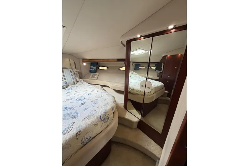 Slide: The Image of Luxurious 2004 Sea Ray 480 Sedan Bridge bedroom with mirrored closet and elegant bedding. - 50