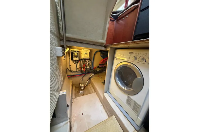 Slide: The Image of 2004 Sea Ray 480 Sedan Bridge interior with washer and electrical panel. - 53