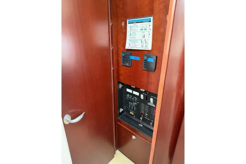 Slide: The Image of Electrical panel inside 2004 Sea Ray 480 Sedan Bridge yacht, featuring control switches and instructions. - 57