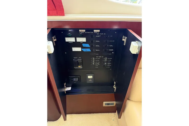 Slide: The Image of Electrical panel inside 2004 Sea Ray 480 Sedan Bridge yacht, showing switches and gauges. - 58
