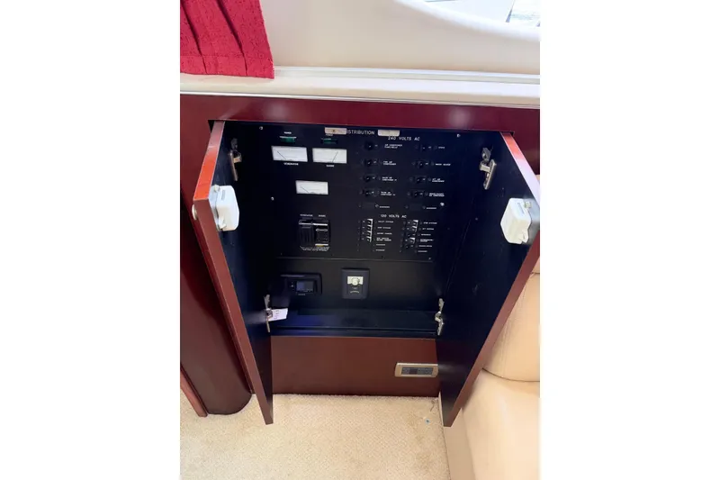Slide: The Image of Electrical panel inside 2004 Sea Ray 480 Sedan Bridge yacht, featuring various switches and controls. - 59