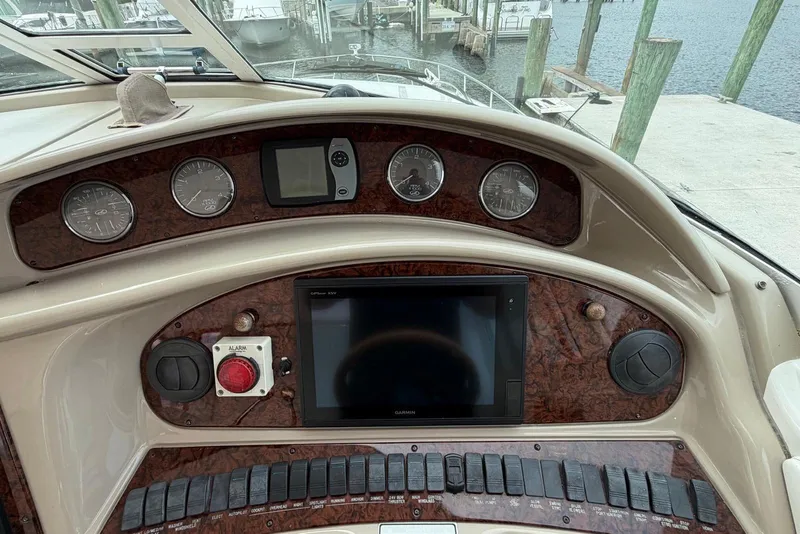 Slide: The Image of 2004 Sea Ray 480 Sedan Bridge dashboard with gauges and navigation controls. - 8