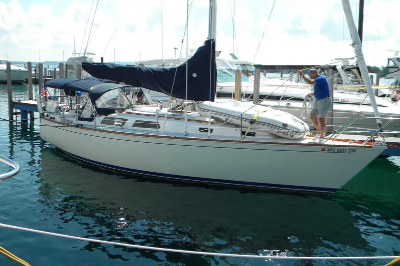 The Image of 1986 Sabre 34 MK II sailboat docked with a person on deck. - 0