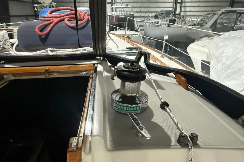 Slide: The Image of 1986 Sabre 34 MK II sailboat deck with winch and ropes in marina. - 11