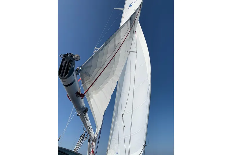 Slide: The Image of 1986 Sabre 34 MK II sailboat with sails unfurled against clear blue sky. - 19