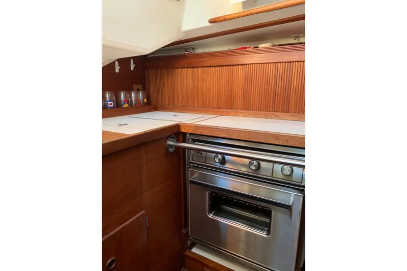 Slide: The Image of 1986 Sabre 34 MK II yacht kitchen with wooden cabinetry and stainless steel oven. - 27