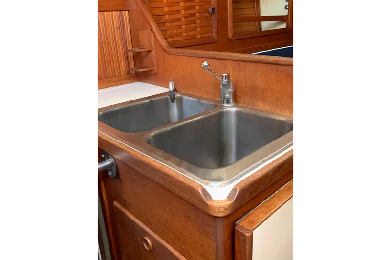 Slide: The Image of 1986 Sabre 34 MK II yacht kitchen sink with wooden cabinetry. - 29