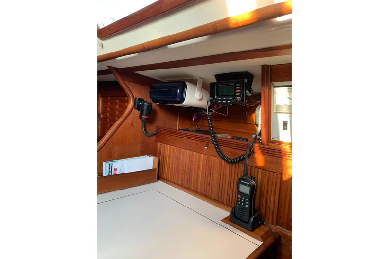 Slide: The Image of 1986 Sabre 34 MK II yacht interior with navigation equipment and wooden paneling. - 35