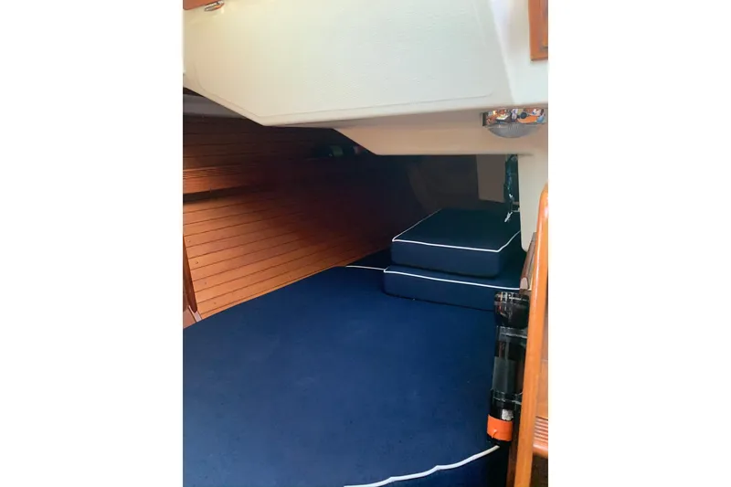 Slide: The Image of Interior cabin of 1986 Sabre 34 MK II sailboat with blue cushions and wooden paneling. - 38