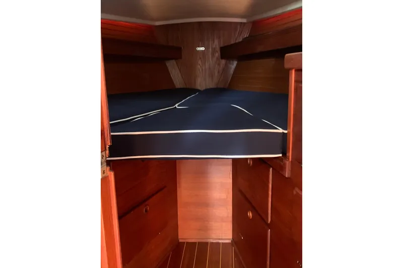 Slide: The Image of 1986 Sabre 34 MK II cabin interior with wooden finish and blue mattress. - 48