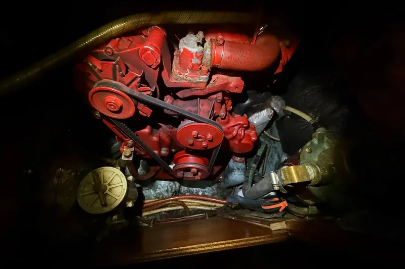 Slide: The Image of Engine compartment of a 1986 Sabre 34 MK II sailboat, featuring a red engine. - 56