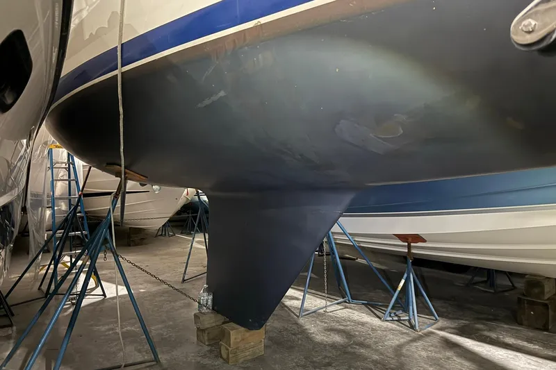 Slide: The Image of 1986 Sabre 34 MK II sailboat hull in storage, supported by stands. - 57