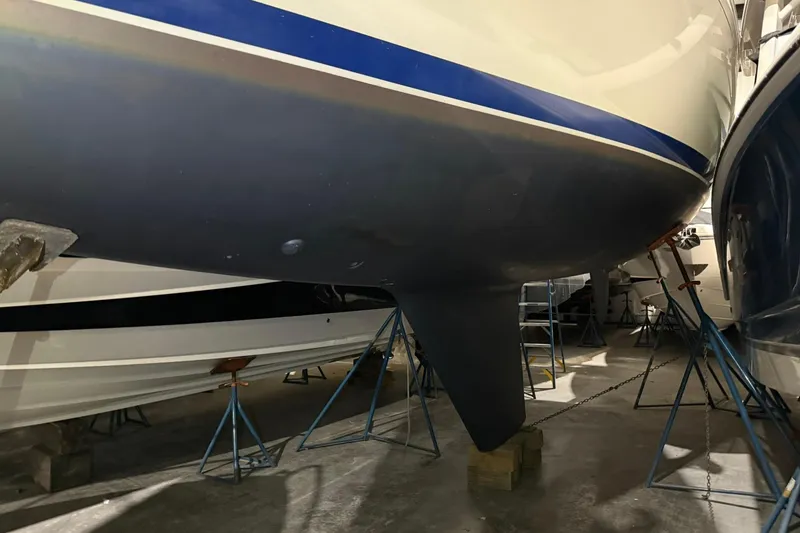 Slide: The Image of 1986 Sabre 34 MK II sailboat hull in storage, supported by stands. - 58